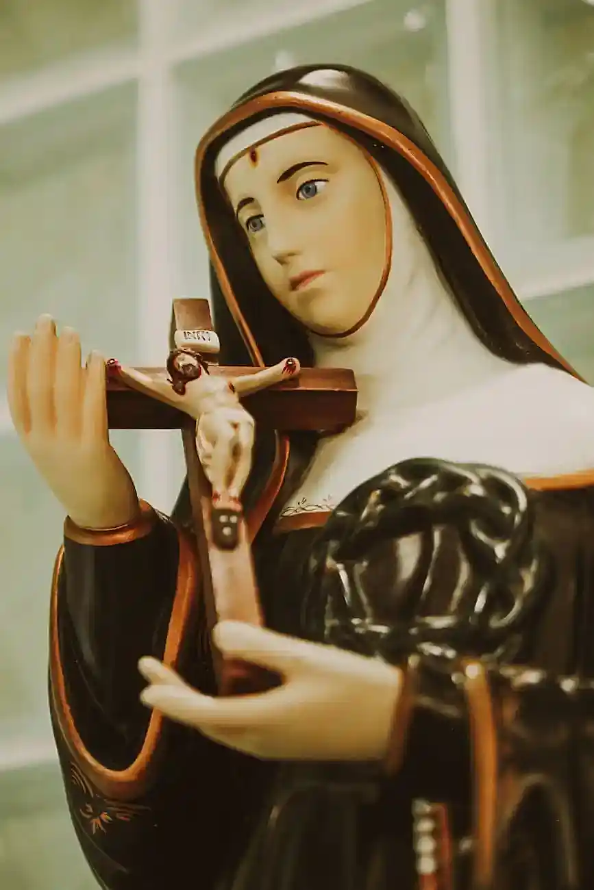 figurine of mother mary holding cross with jesus