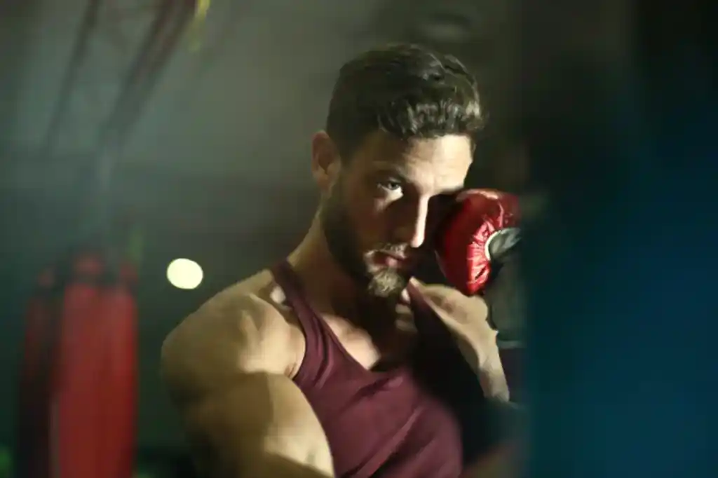 close up photography of man wearing boxing gloves